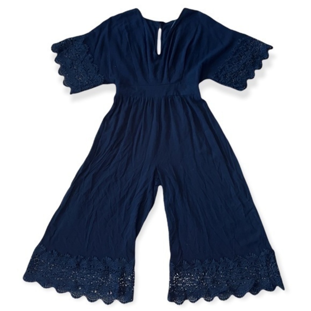 Entro V-neck jumpsuit featuring crochet lace detail at sleeves and hem
